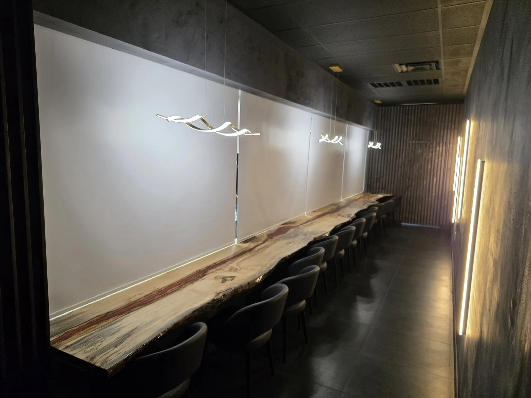 Commercial roller shades installed along a restaurant window wall